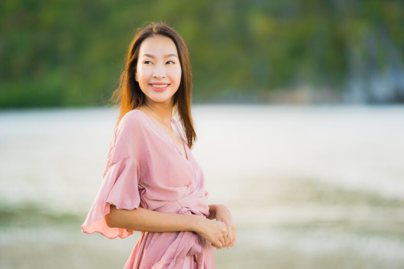 Portrait beautiful young asian woman smile happy walk on the tropical outdoor nature beach sea for leisure vacation