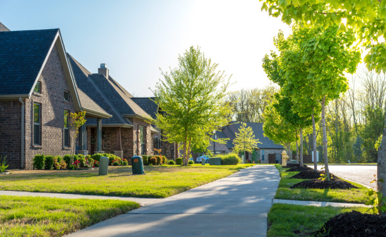 View of modern residential houses neighborhood street in Bentonville, Northwest Arkansas, sunny flare day, fast growing city lifestyle