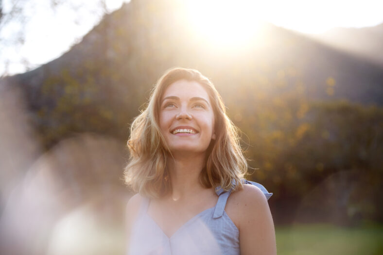 happy sunrise woman with beautiful smile full of optimism