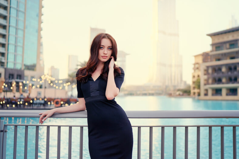 Portrait of beautiful caucasian woman with charming smile and long hair walking on the Dubai street.