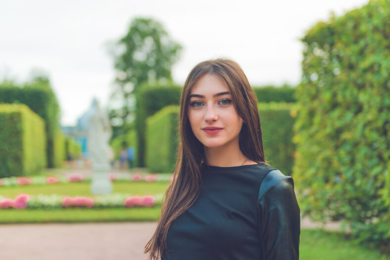 Portrait of charming russian brunette woman with stunning eyes looking at camera. Beautiful woman face.