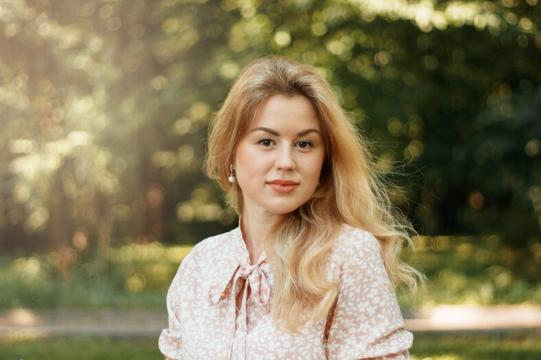 Summer portrait of a young blonde woman with brown eyes