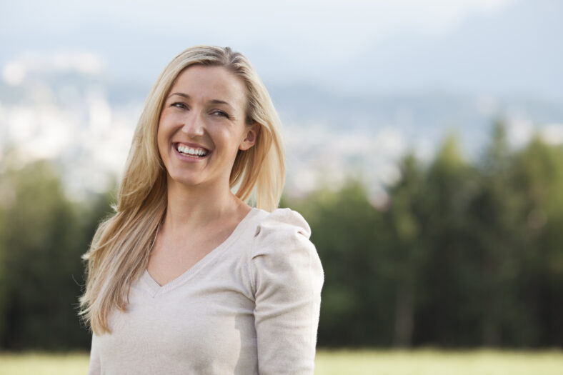 pretty young blonde woman standing outside