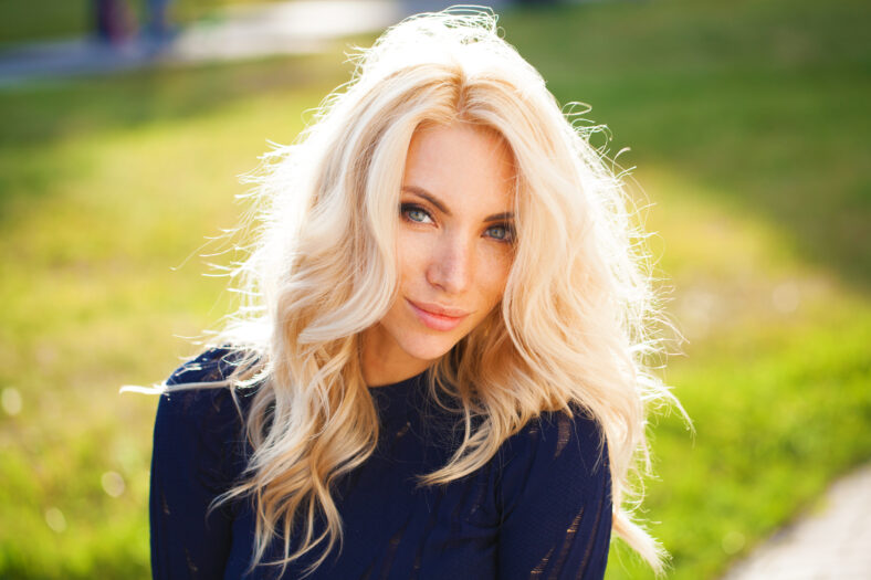 Portrait close up of young beautiful blonde woman, summer outdoors