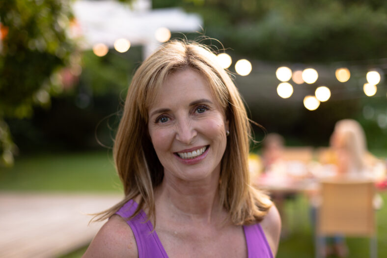 Caucasian woman smiling and looking at camera