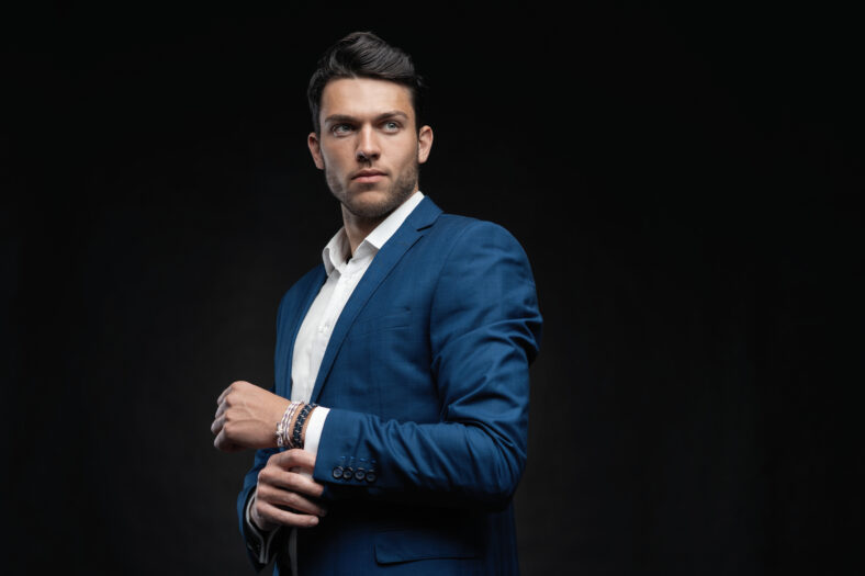 Handsome man wear blue suit isolated on black background