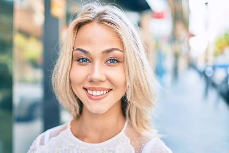 Young caucasian girl smiling happy walking at street of city.