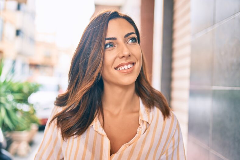 Young hispanic woman smiling happy walking at the city.