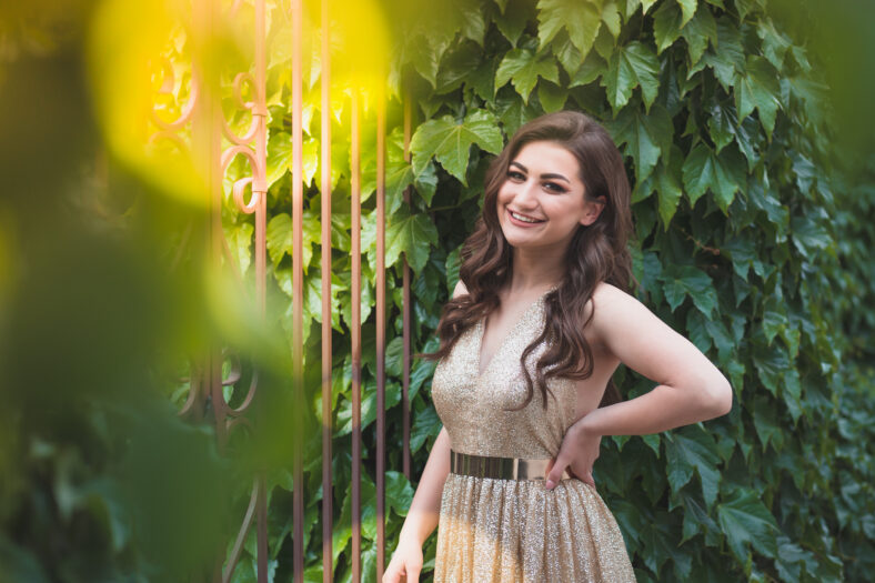 Beautiful teen girl in glamorous golden dress. Prom fashion