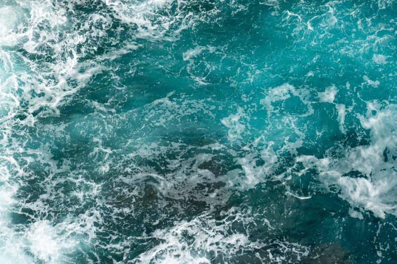 Sea foam and waves aerial overhead