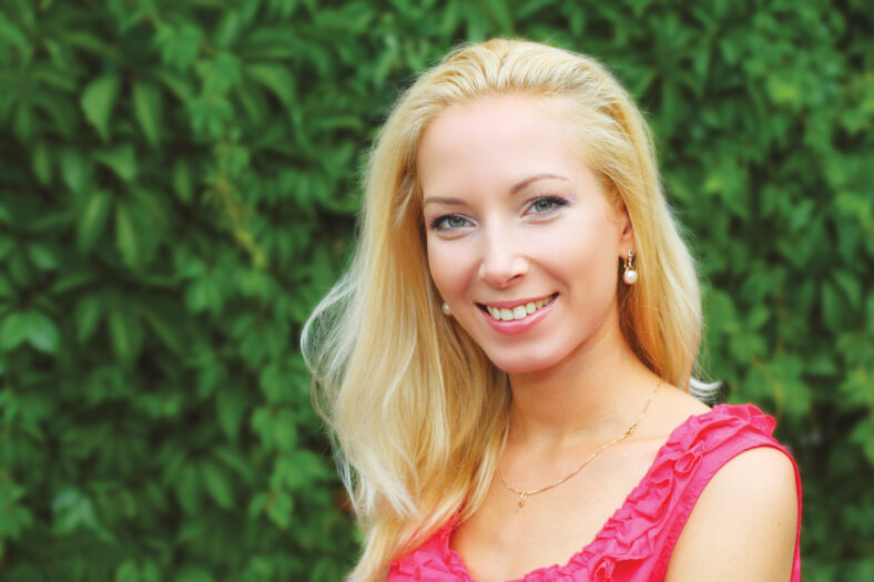 Portrait of young pretty blond woman outdoors
