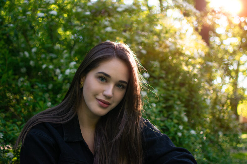 Young smiling hair woman portrait on sunset in nature