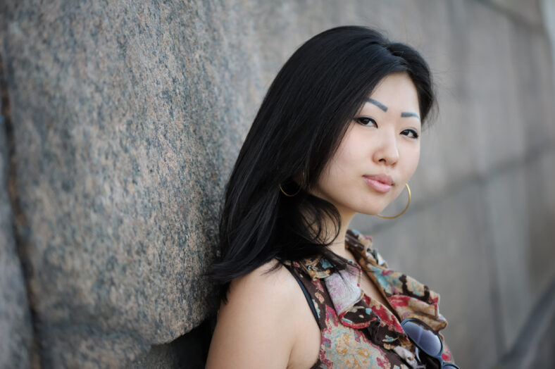 Portrait of asian woman near the wall
