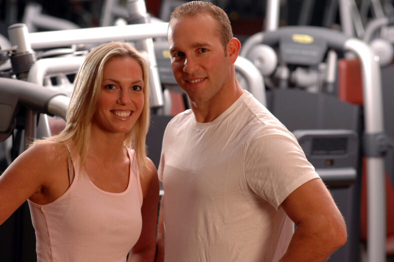 happy fitness couple in the gym