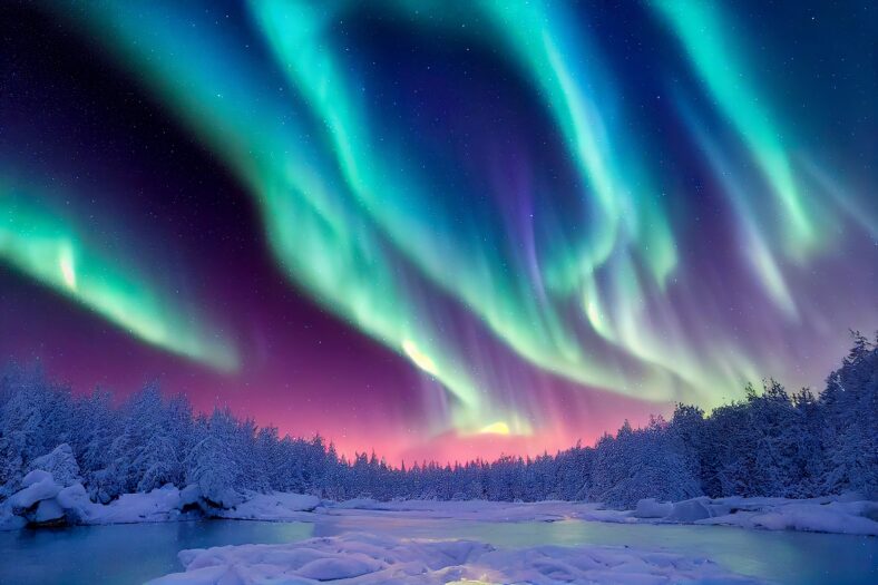 Aurora borealis on the Norway. Green northern lights above mountains. Night sky with polar lights. Night winter landscape with aurora and reflection on the water surface. Natural back