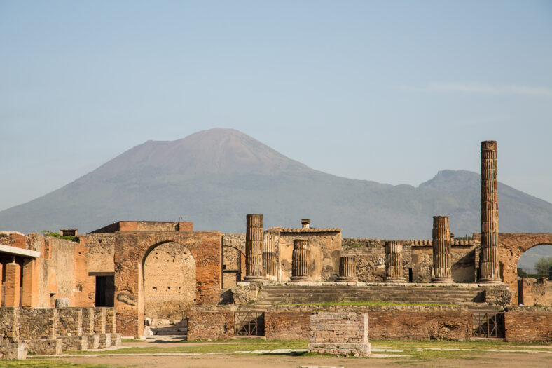 Ancient walls in Pompeii with volcano Vesuvius in the background