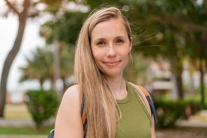 Young blonde woman at outdoors . Portrait