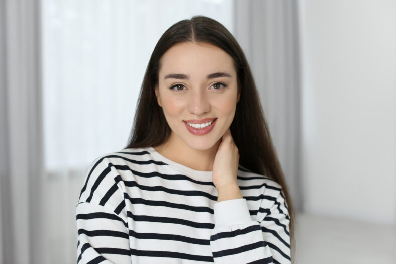 Portrait of beautiful young woman at home