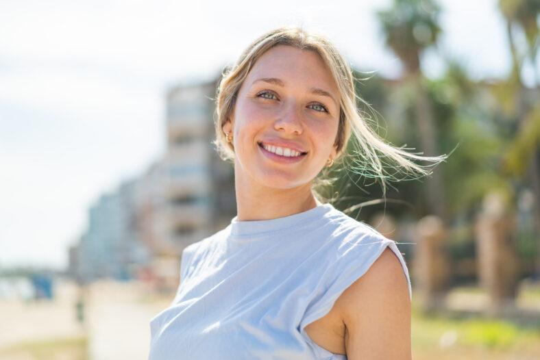 Young blonde woman at outdoors wearing sport wear
