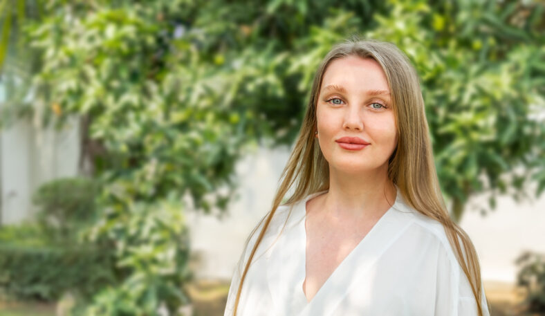 Portrait of a young woman outdoors in the backyard