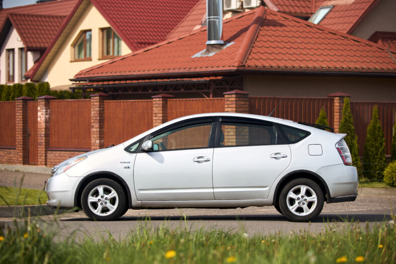 Toyota Prius XW20 2009 hybrid electric car over out of focus rural background left side view