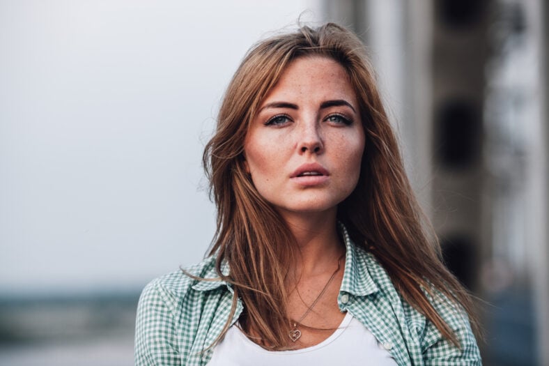 closeup head and shoulders portrait of young adult beautiful woman
