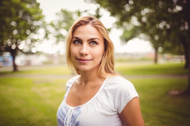 Smiling woman standing in park