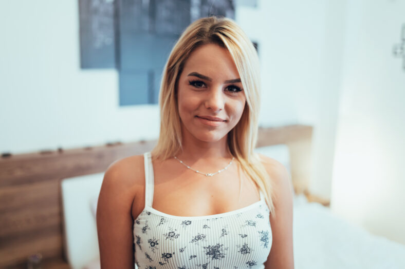 Portrait of a beautiful blonde in bedroom