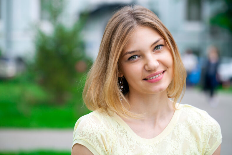 Portrait close up of young beautiful happy woman, summer outdoors