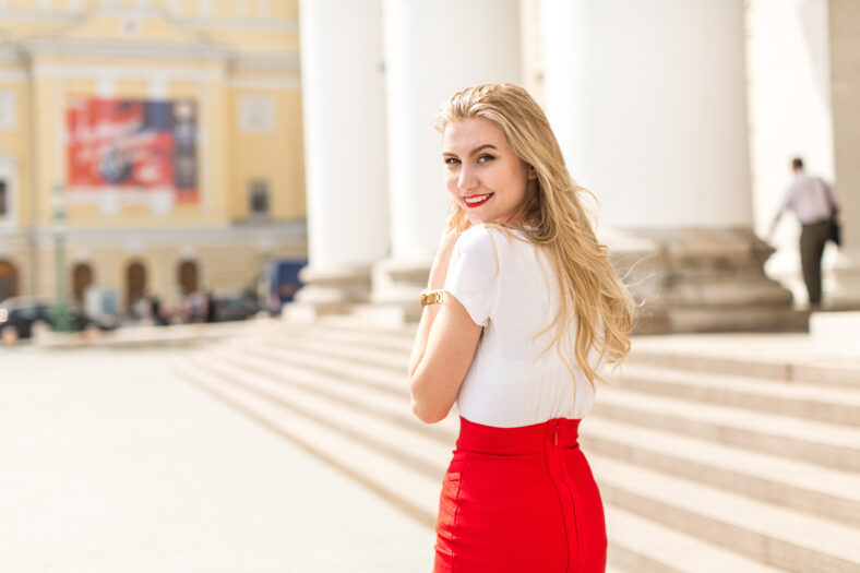 Young beautiful woman with long hair walking in city