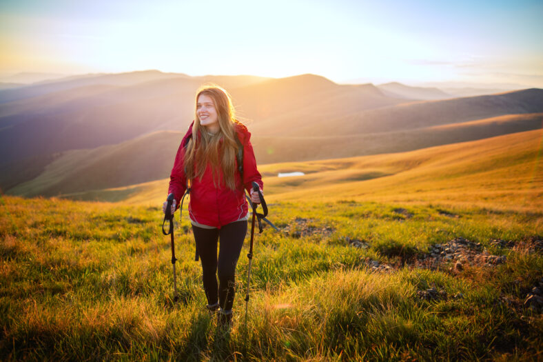 Shot of a young woman looking at the landscape while hiking in the mountains