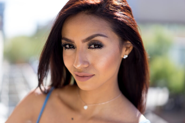 Beautiful woman with red hair outside on hot summer day