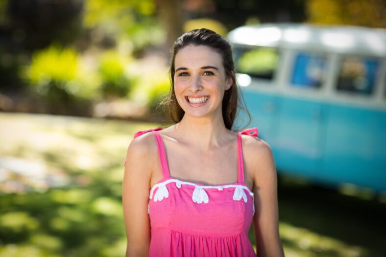 Smiling woman standing in park