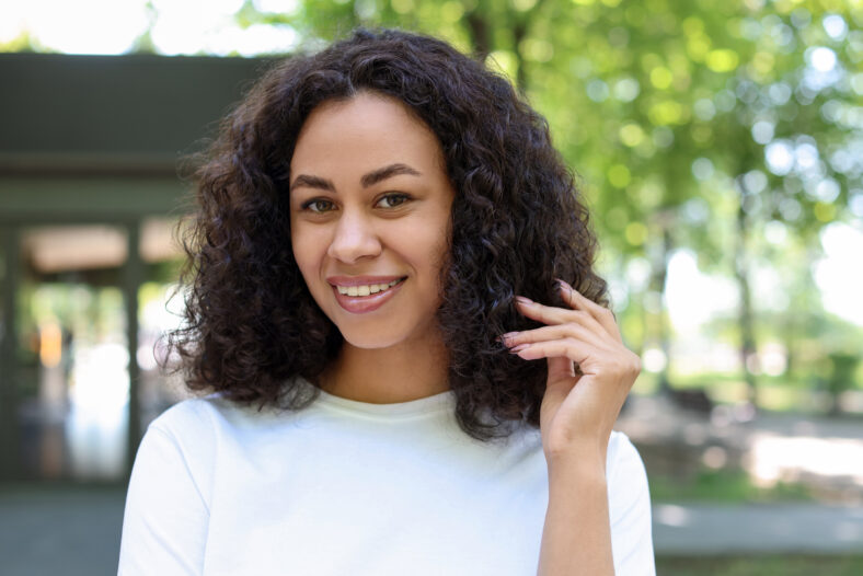 Portrait of smiling Latin American woman outdoors