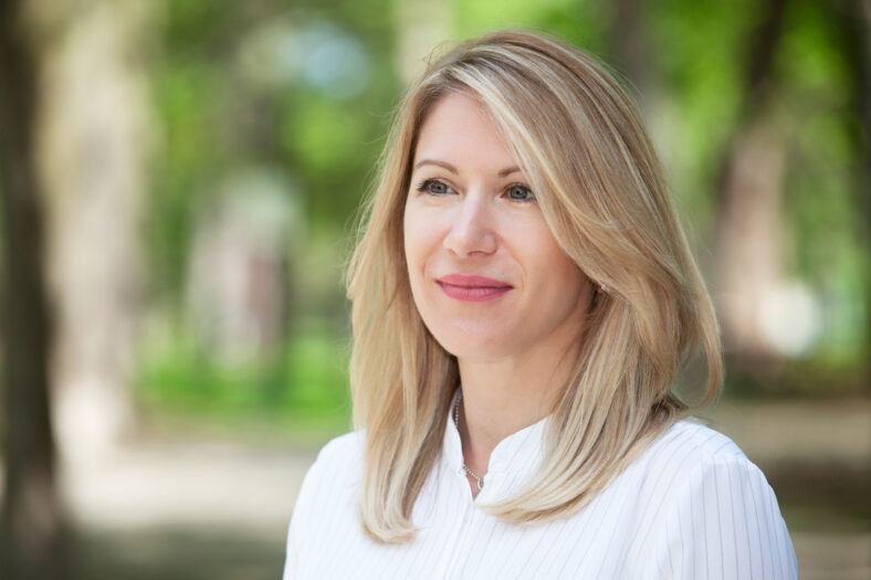 Close Up Of A mature Happy Blond Woman Smiling And Looking away. Thirties.