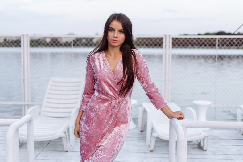fashion portrait of happy beautiful Hispanic latino girl in purple dress with long hair