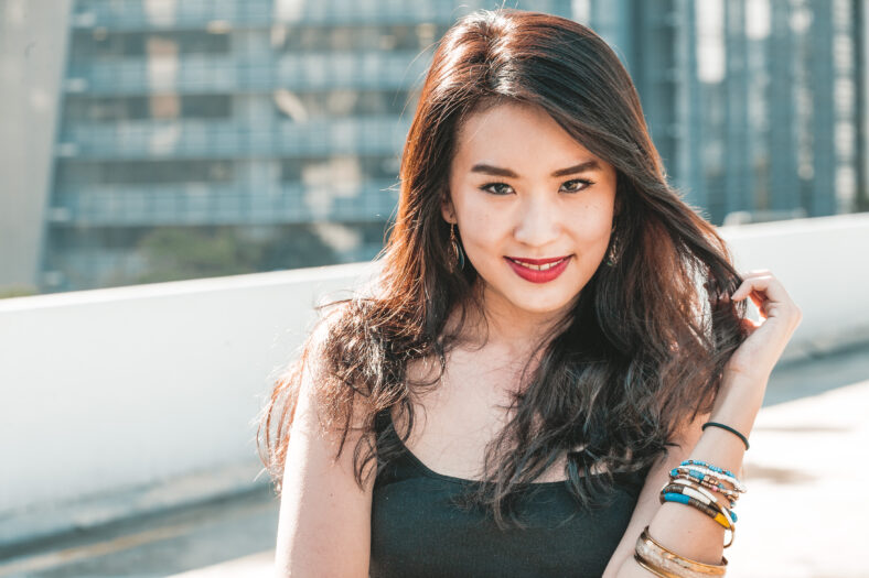 Portrait of Young Asian woman on rooftop in urban cityscape
