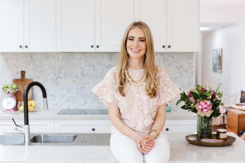 Portrait of an interior designer sitting on a kitchen bench