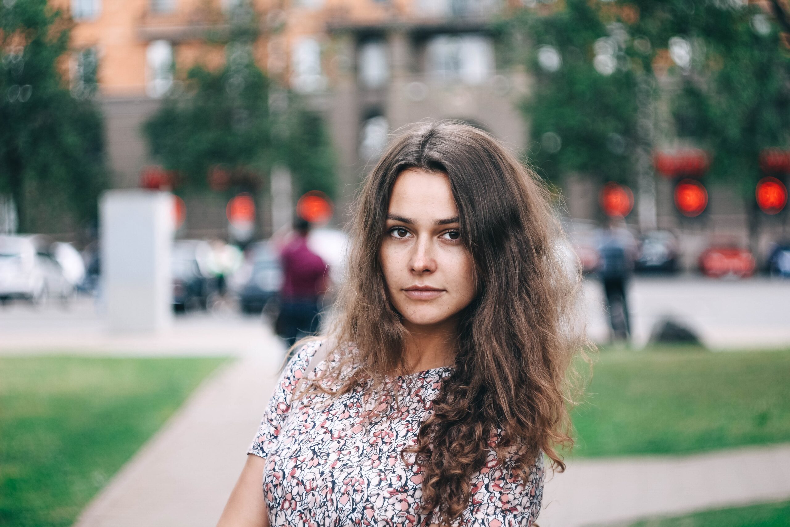 portrait of a charming curly-haired girl on a walk in the city.