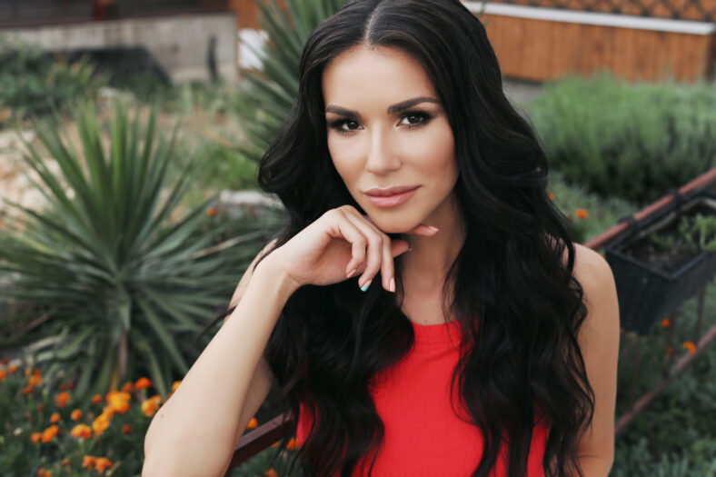 fashion outdoor photo of beautiful woman with dark hair in casual clothes