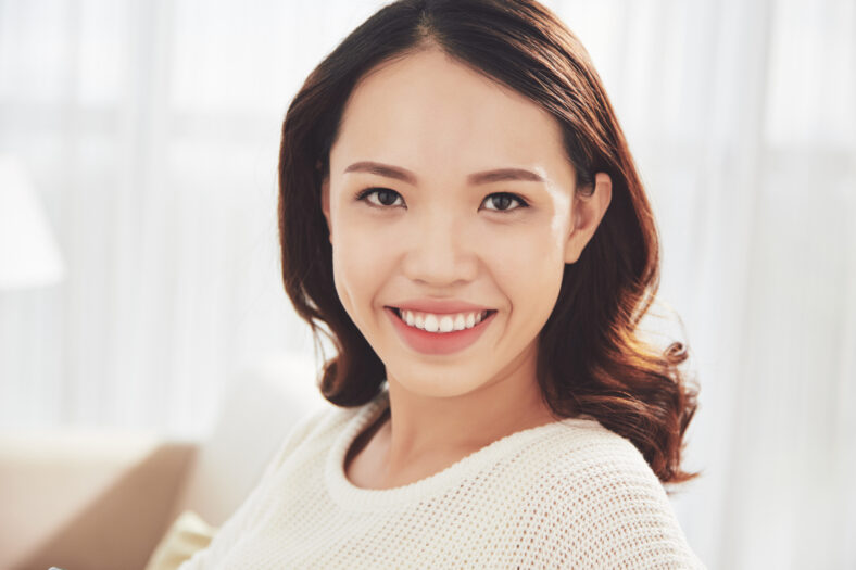 Fresh face of beautiful young smiling Vietnamese woman