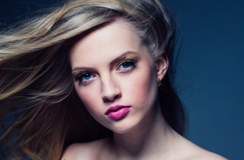 Beautiful blonde hair woman with beauty makeup pink lipstick