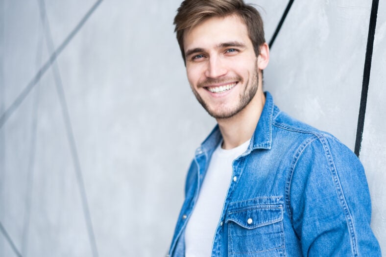 Perfect man. Portrait of happy fashionable handsome man in jeans shirt