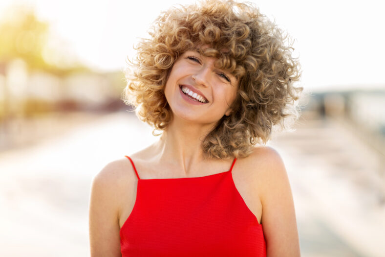 Portrait of young woman with curly hair