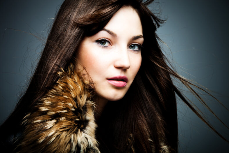 woman in leather jacket with fur portrait studio shot