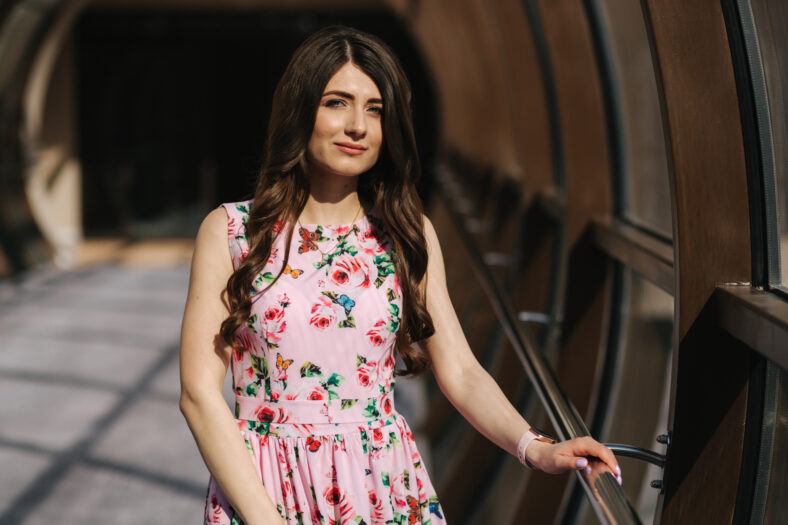 Portrait of beautiful young girl in flower dress with fashion makeup.