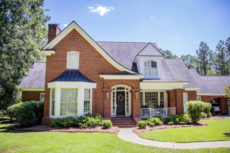 Large Red Brick Traditional Colonial Home House on a large Woode