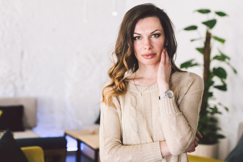 Good looking mid aged woman portrait at home. Elegant Business Woman. Middle-Aged Woman Standing In Modern Home.