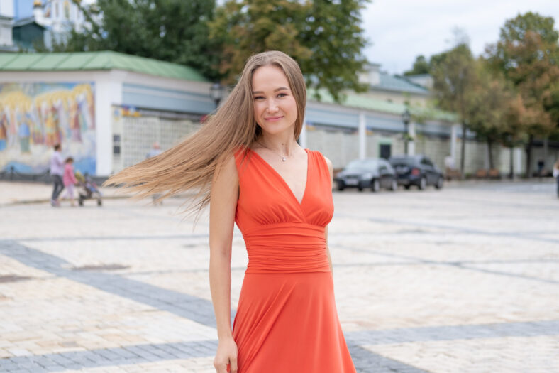 Attractive, Slim, Beautiful Girl Wearing White Shirt And Maxi Long Red Silk Fabric Skirt Fly And Wave In The Wind Walking. Fashion Concept