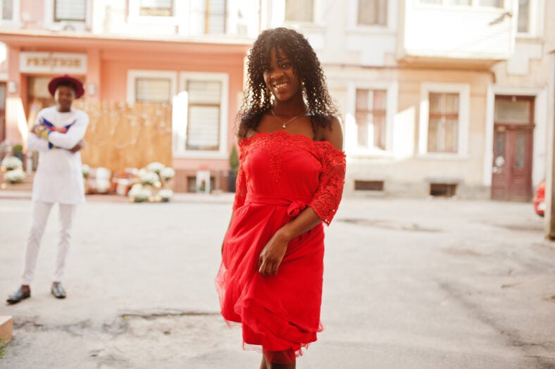 Stylish trendy afro france curly woman posed at autumn day in red dress. Black african female model.